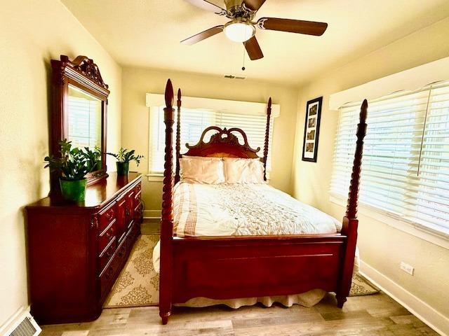 bedroom with hardwood / wood-style flooring and ceiling fan