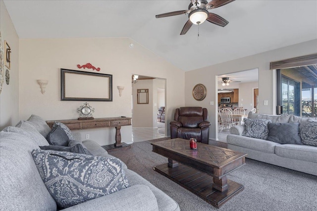 living room with ceiling fan and lofted ceiling