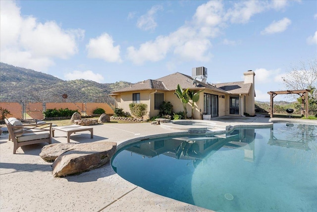 view of pool with a mountain view, a pergola, a patio, and an in ground hot tub