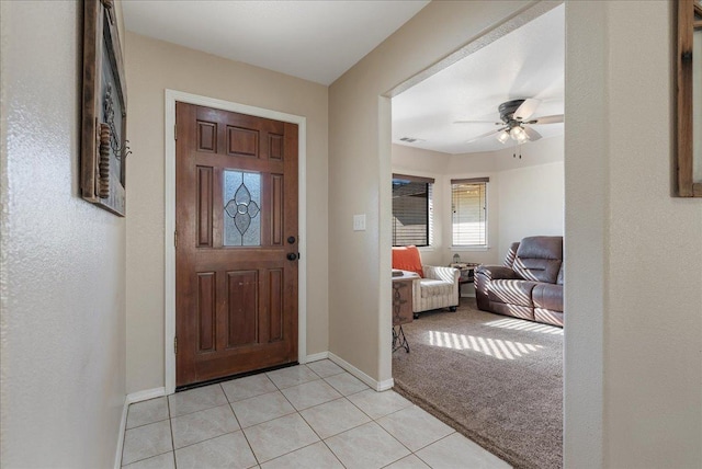 tiled entrance foyer featuring ceiling fan