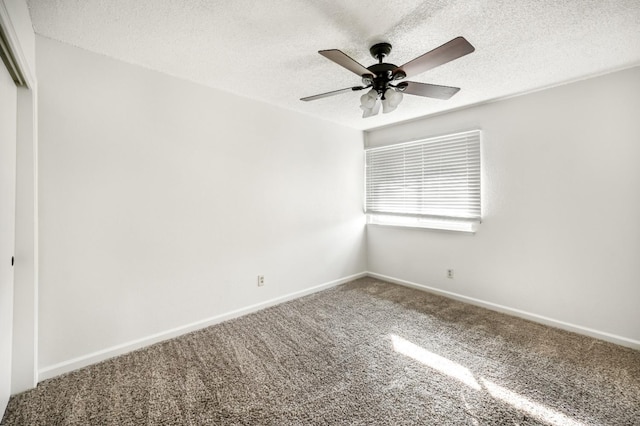 empty room featuring ceiling fan, a textured ceiling, and carpet