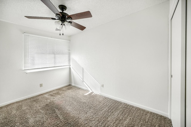 unfurnished room featuring ceiling fan, carpet, and a textured ceiling