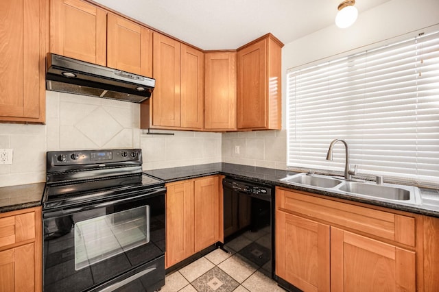 kitchen featuring tasteful backsplash, dark stone countertops, sink, and black appliances