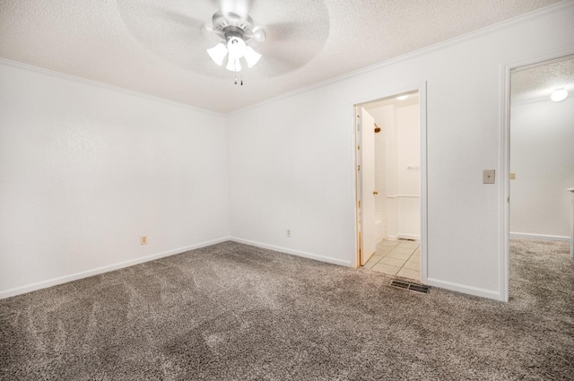 unfurnished bedroom with ensuite bathroom, crown molding, a textured ceiling, ceiling fan, and light colored carpet