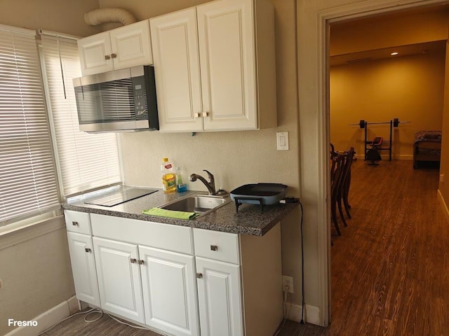 kitchen with white cabinetry, sink, and dark hardwood / wood-style flooring