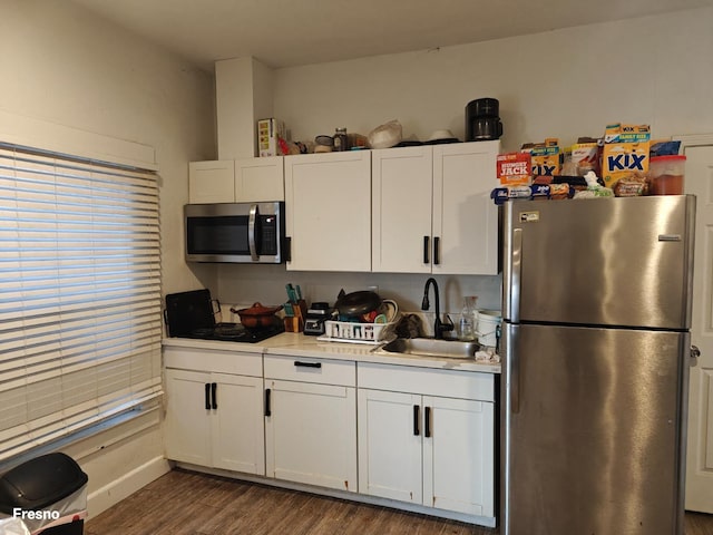 kitchen with white cabinetry, stainless steel appliances, dark hardwood / wood-style flooring, and sink