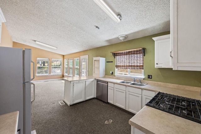 kitchen with dishwasher, white cabinetry, sink, white refrigerator, and kitchen peninsula