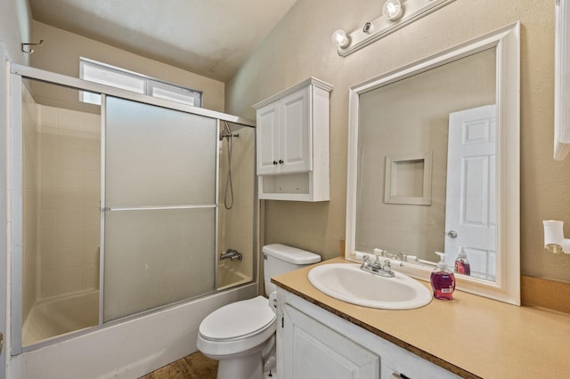 full bathroom with vanity, toilet, and combined bath / shower with glass door