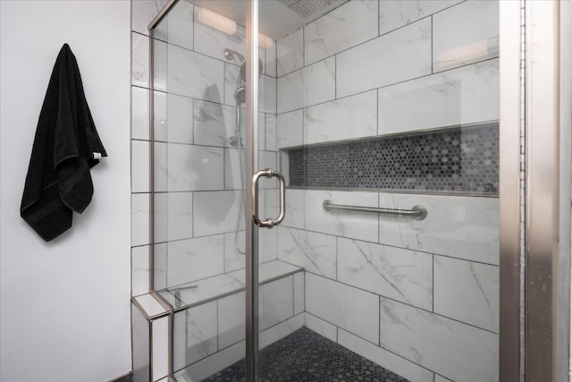 bathroom with a shower with shower door