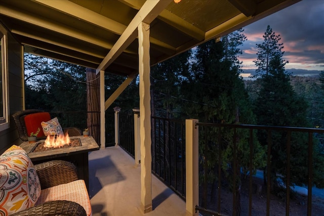 patio terrace at dusk featuring a fire pit