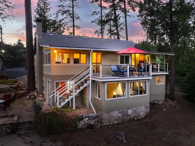 view of back house at dusk