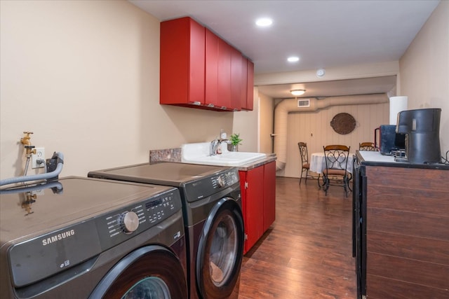 laundry area with sink, dark wood-type flooring, and washing machine and dryer