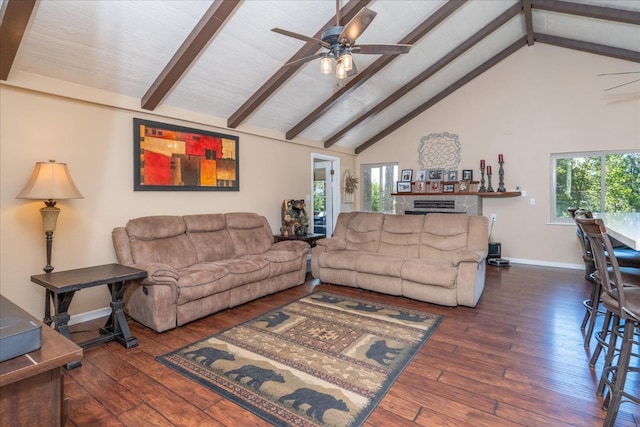 living room featuring plenty of natural light, dark hardwood / wood-style floors, and beamed ceiling