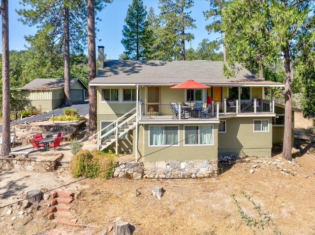 back of property featuring a balcony