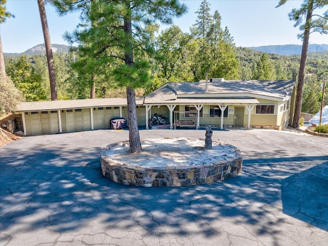 single story home featuring a garage and a mountain view