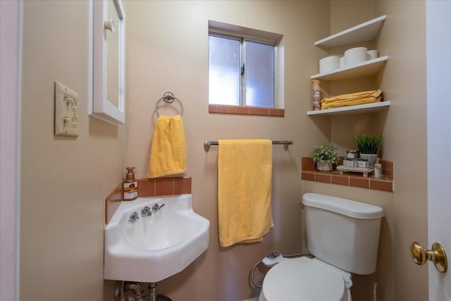 bathroom featuring sink and toilet