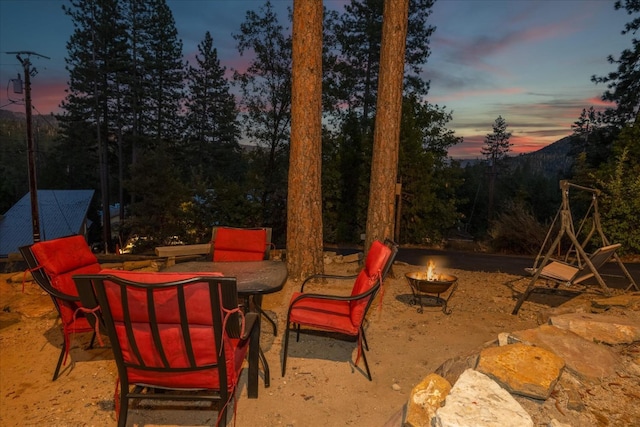 patio terrace at dusk with an outdoor fire pit