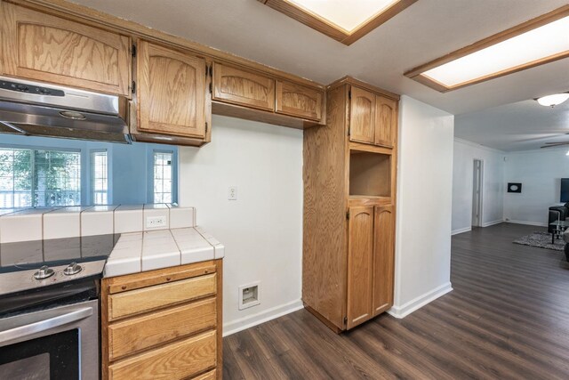 kitchen with tile counters, dark hardwood / wood-style flooring, and electric stove