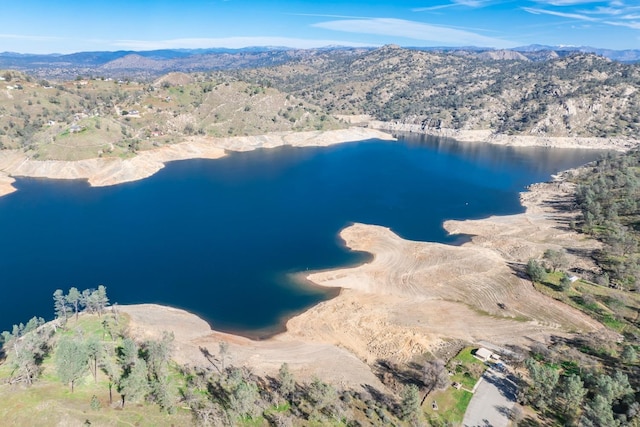 drone / aerial view featuring a water and mountain view