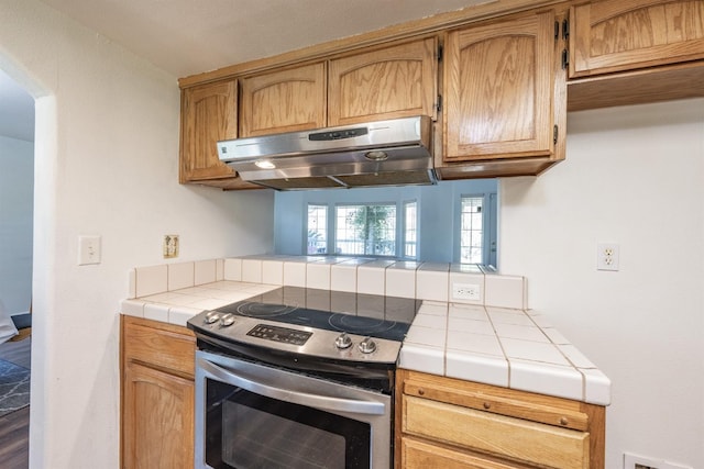 kitchen featuring tile counters and electric stove