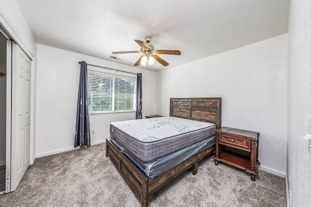 carpeted bedroom featuring ceiling fan and a closet