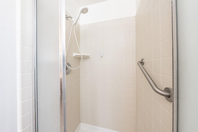 bathroom with a shower with door