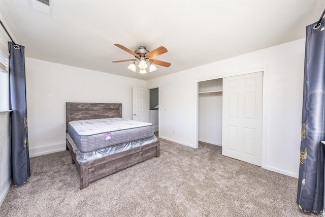 bedroom featuring light carpet, ceiling fan, and a closet