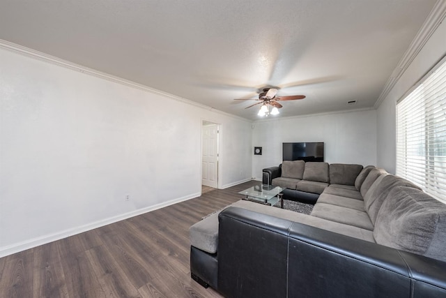 living room with dark hardwood / wood-style flooring, crown molding, and ceiling fan