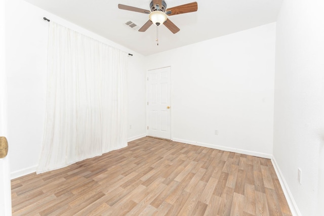 empty room with light hardwood / wood-style floors and ceiling fan