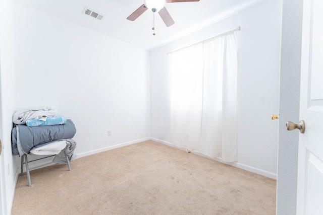 carpeted spare room featuring ceiling fan