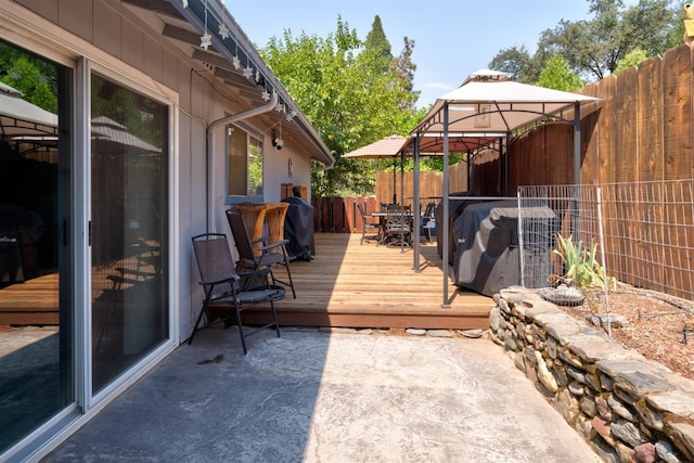 wooden terrace featuring a gazebo and grilling area