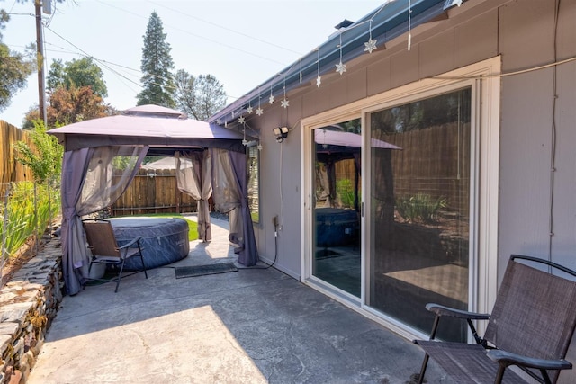 view of patio / terrace with a gazebo and a hot tub