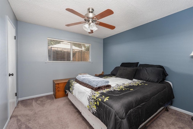 bedroom featuring ceiling fan, light carpet, and a textured ceiling