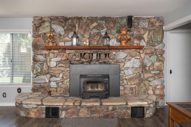 room details with hardwood / wood-style flooring and a wood stove