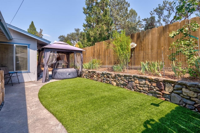 view of yard with a gazebo, a patio area, and a hot tub