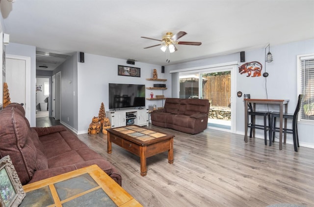 living room featuring hardwood / wood-style flooring and ceiling fan