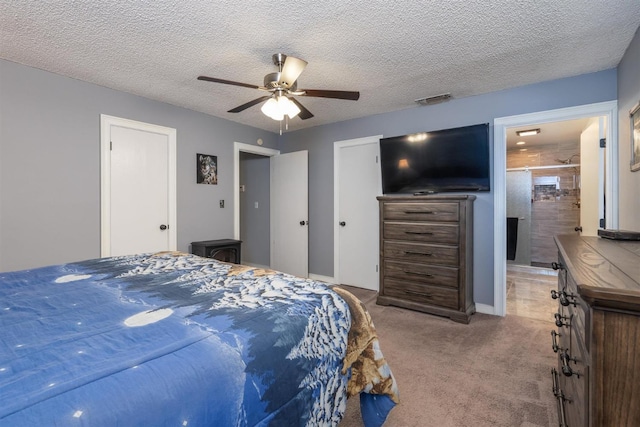 carpeted bedroom with ceiling fan and a textured ceiling