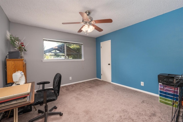 carpeted office space featuring ceiling fan and a textured ceiling