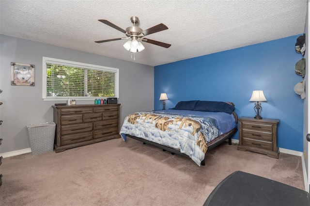 carpeted bedroom with ceiling fan and a textured ceiling