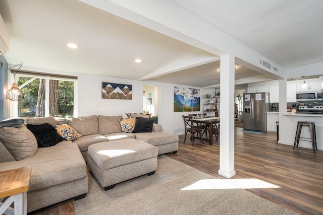 living room with dark hardwood / wood-style flooring and beam ceiling