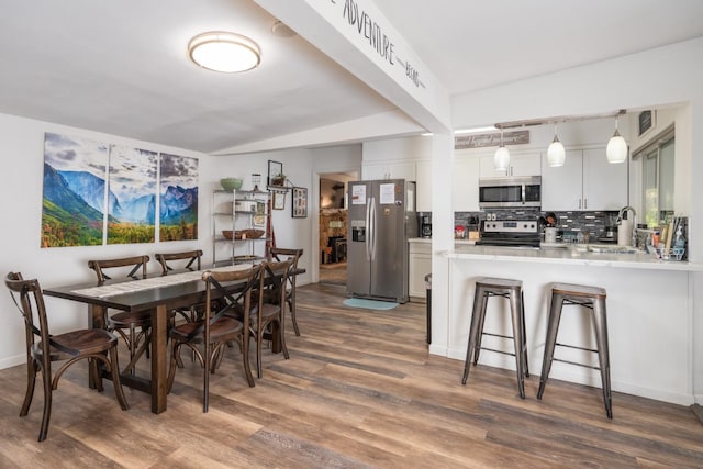 dining room featuring dark hardwood / wood-style flooring and sink