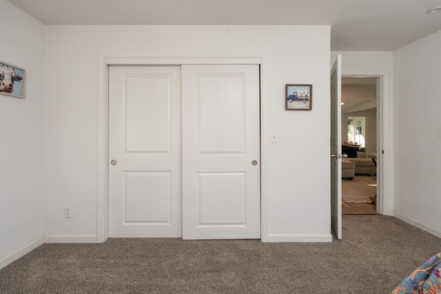 unfurnished bedroom with a closet and carpet