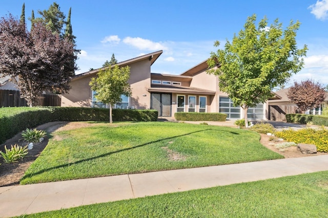 view of front of home with a garage and a front yard