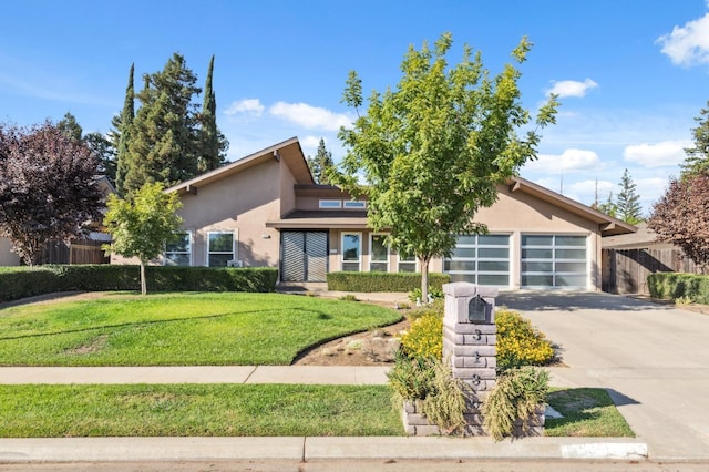 view of front of house with a garage and a front lawn