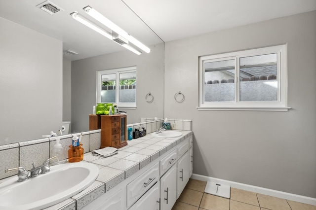 bathroom featuring vanity, tile patterned floors, and toilet