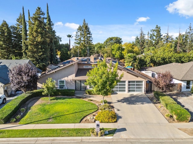 front of property with a garage and a front lawn