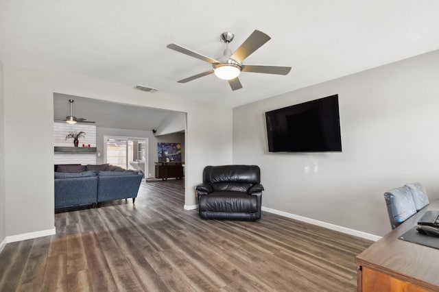 living room with ceiling fan and dark hardwood / wood-style flooring