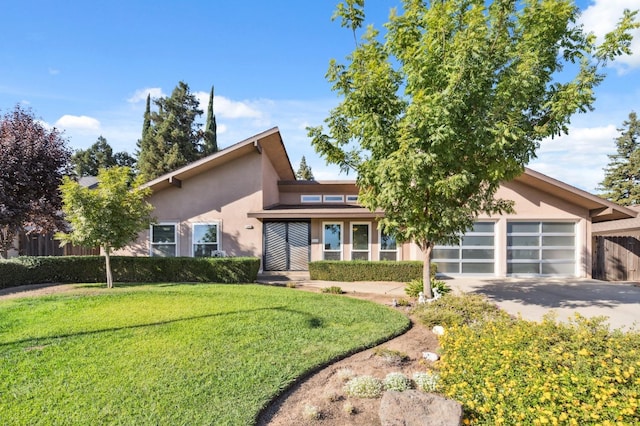 view of front of house featuring a garage and a front lawn