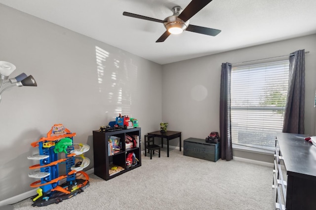 playroom with light colored carpet and ceiling fan