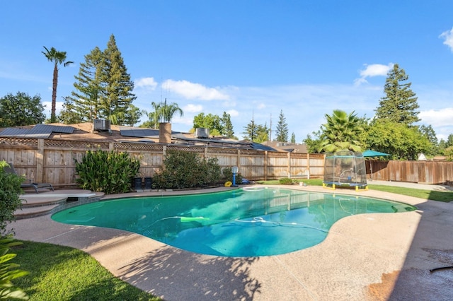 view of swimming pool featuring central AC and a trampoline